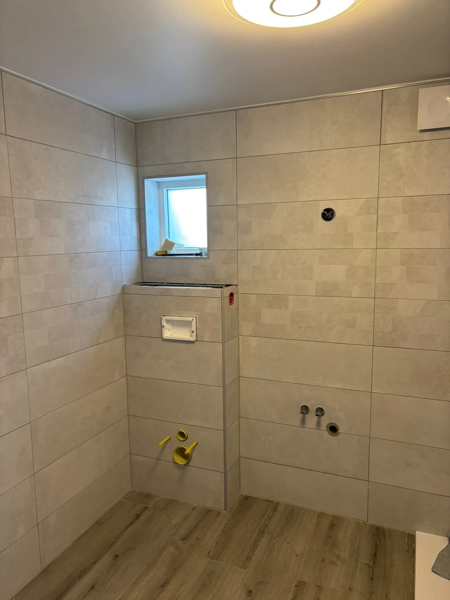 Installation bâti support WC suspendu Geberit avec carrelage contemporain